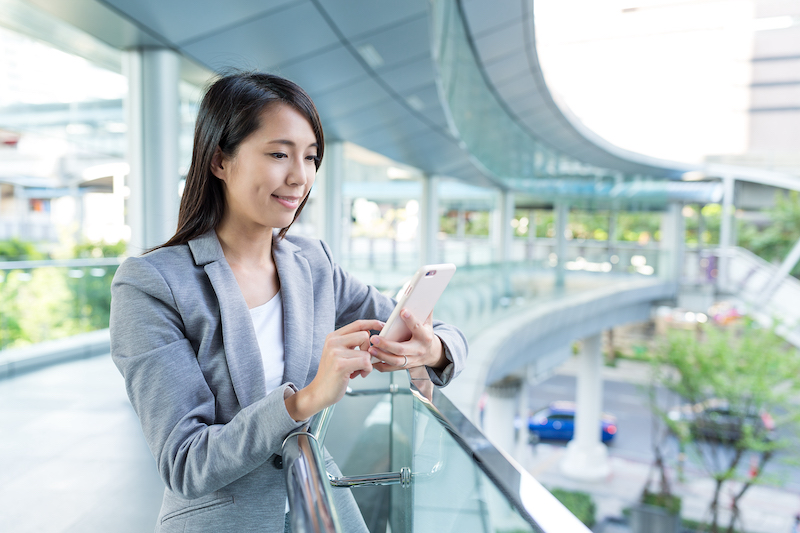 Business woman looking at smart phone