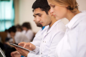 BS/MD students using tablet computer during lecture, conference or symposium