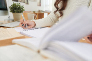 Student starting to think about applying for college taking notes