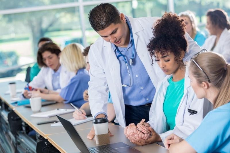 Pre-med student receives help from an instructor in a course