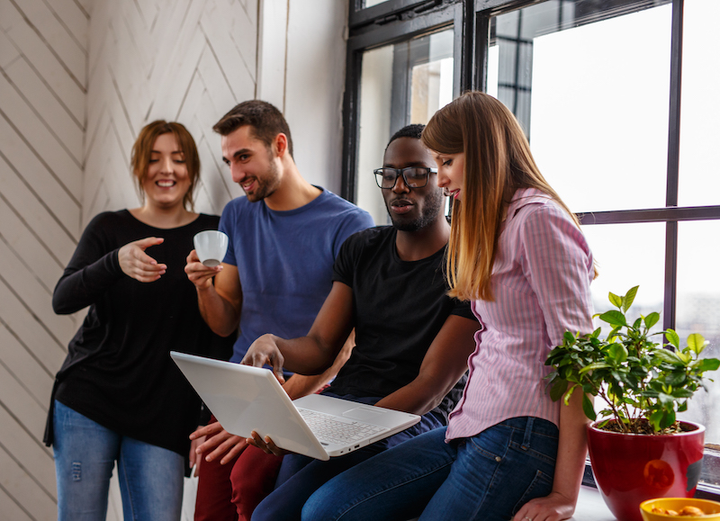 Group of international students using a laptop