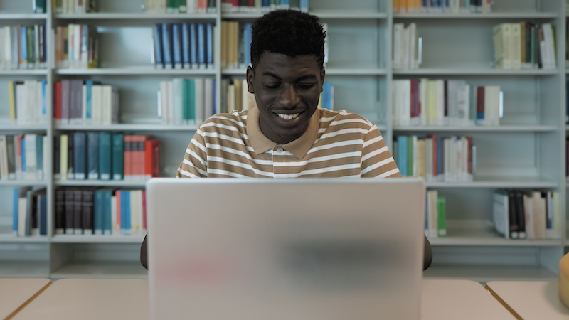 Young male student conducting a college video interview for admissions 