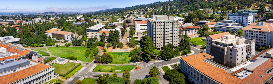 Panoramic view of the University of California, Berkeley campus on a sunny day, view towards Richmond and the San Francisco bay shoreline in the background, California