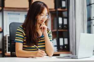 Female student doing Online MBA program on laptop at a desk