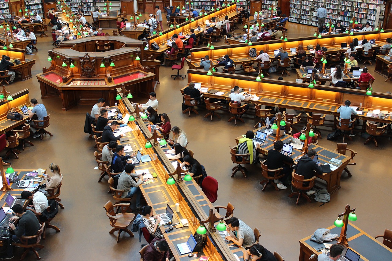 Students studying and reading in university library