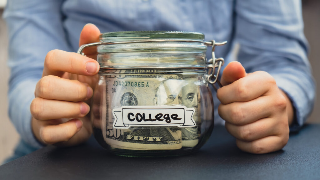 Woman holding a jar with savings money for college.