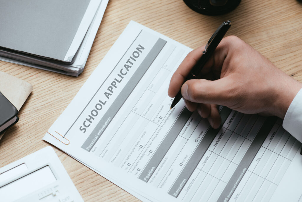 Man filling out a school application