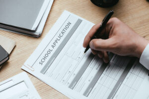 Man filling out a school application