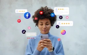 A student checks her phone as social media icons and reactions surround her