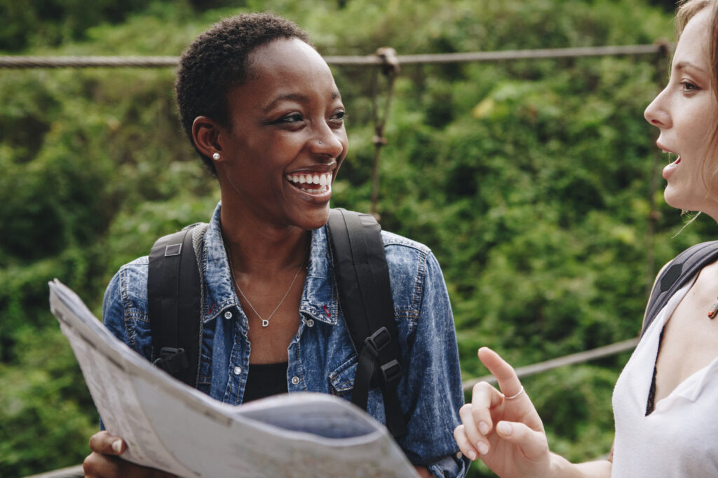 Happy student navigating with a map on campus