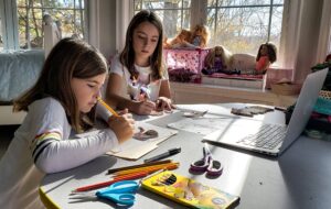 Young siblings at home doing art projects.