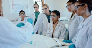 Science, laboratory and teacher with students in class for learning, education and research