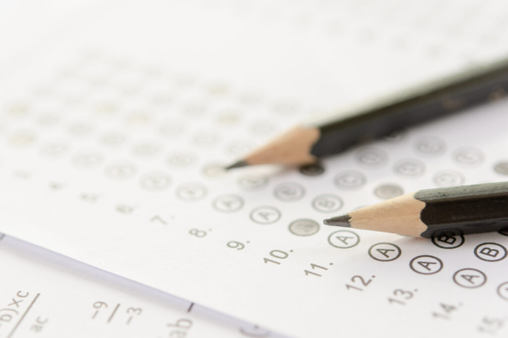 Pencil on answer sheets or Standardized test form with answers bubbled. Multiple choice answer sheet