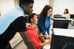 Students using computers during business class at school